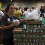 Action team with canned food at LA Food Bank