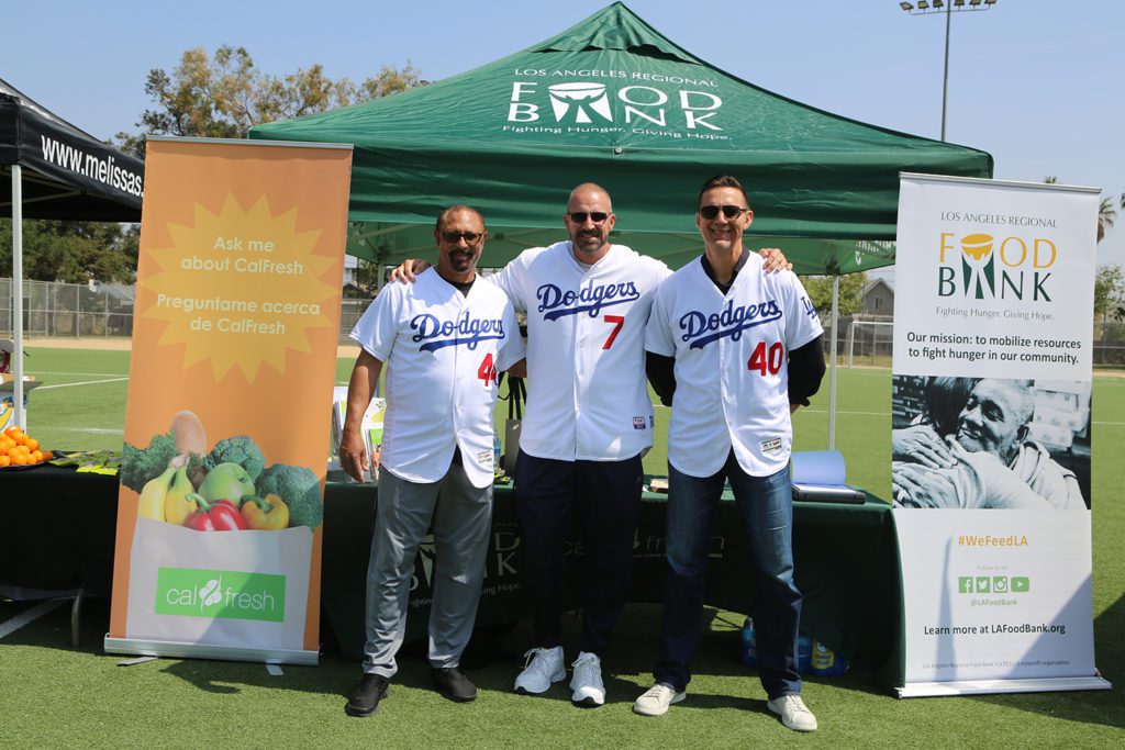 Dodgers Alumni vist the CalFresh Outreach booth at Dodger Days Youth Clinic at Ross Snyder Park