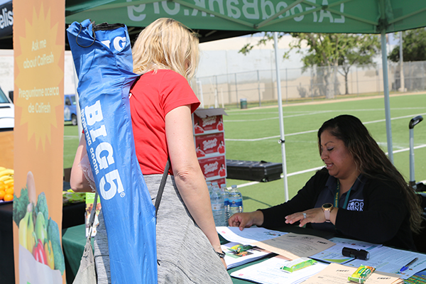 CalFresh Outreach worker provides information about enrollment.