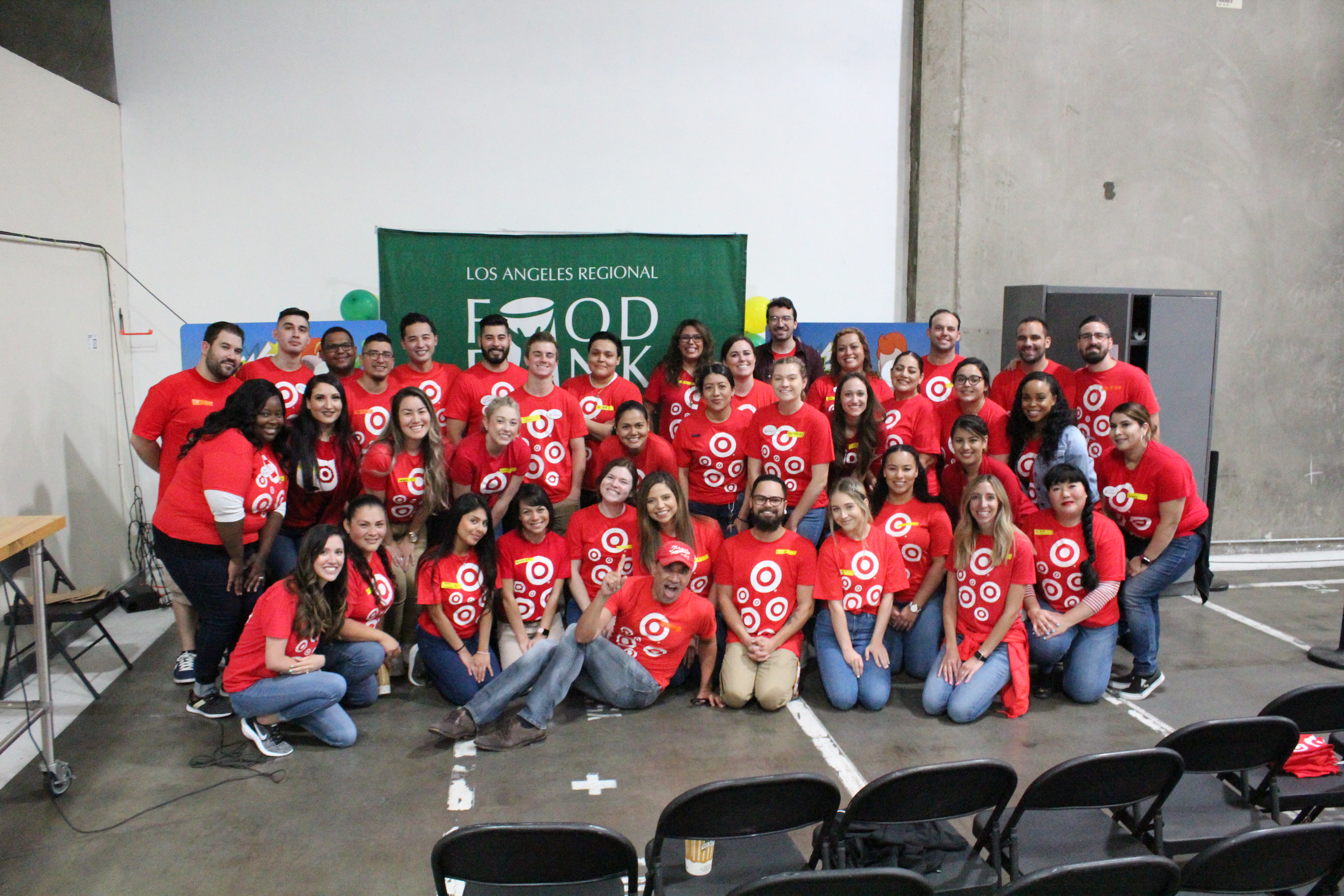 Target volunteers, wearind red shirts, at the LA Regional Food Bank - smiling.