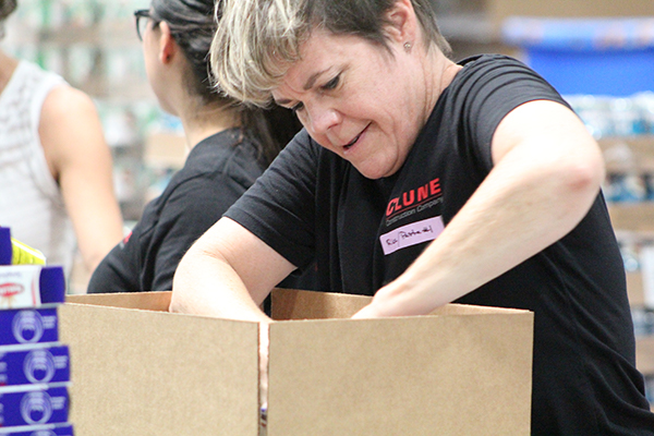 A Clune Construction volunteer packing boxes.