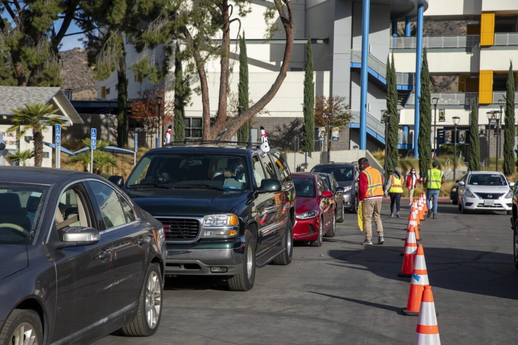 Cars line up for a drive through distribution by the LA Regional Food Bank