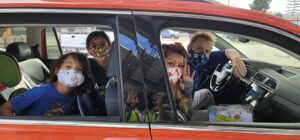 A family in face masks attend a drive through distribution hosted by the LA Regional Food Bank.