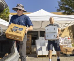 volunteers load at PazNaz load a vehicle with fresh produce and dairy