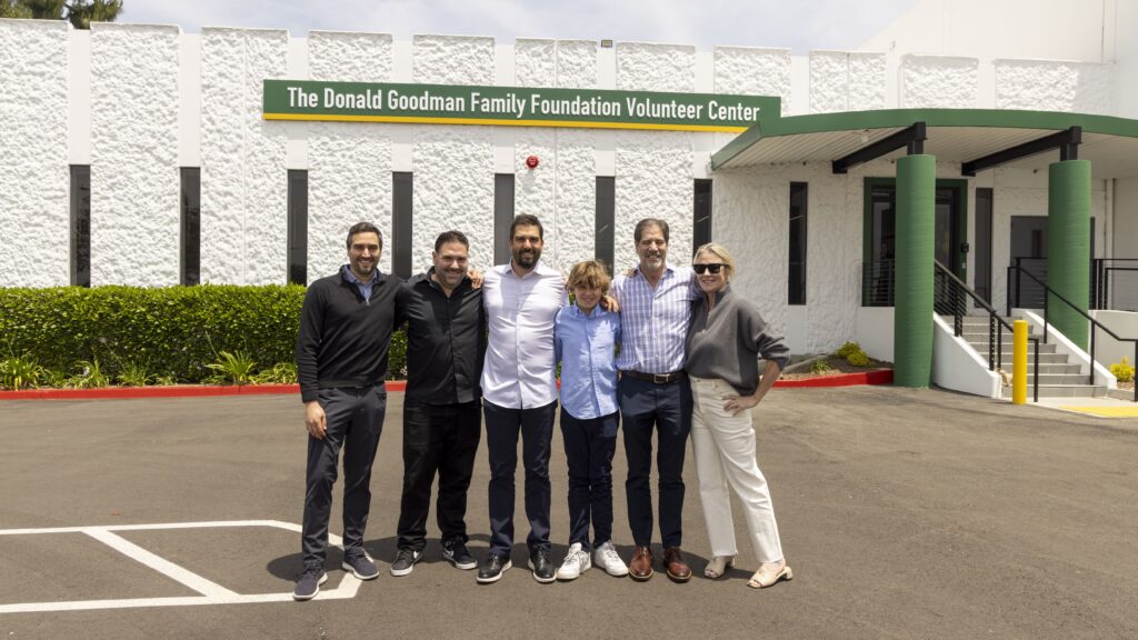 The Donald Goodman Family standing in front of the Donald Goodman Family Foundation Volunteer Center