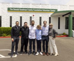 The Donald Goodman Family standing in front of the Donald Goodman Family Foundation Volunteer Center