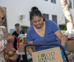 A woman places a box labeled 