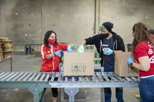 Volunteers from Target and UCLA prepare food kits in the LA Regional Food Bank warehouse in South LA.