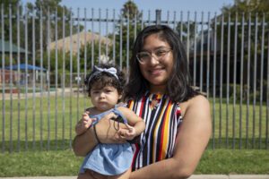 Jacqueline and her baby at LA Regional Food Bank Partner Agency East LA Service Center during a food distribution.