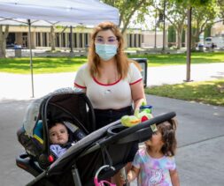 A mother and her two children at a distribution at Citrus College