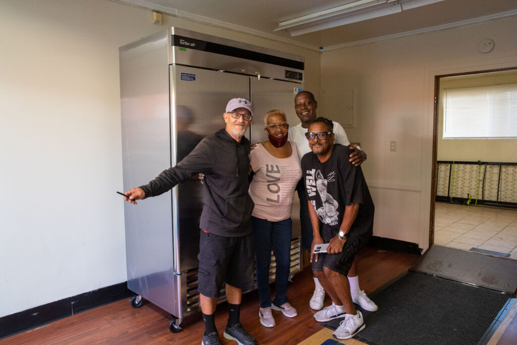 Bryant Temple staff with their new refrigerator