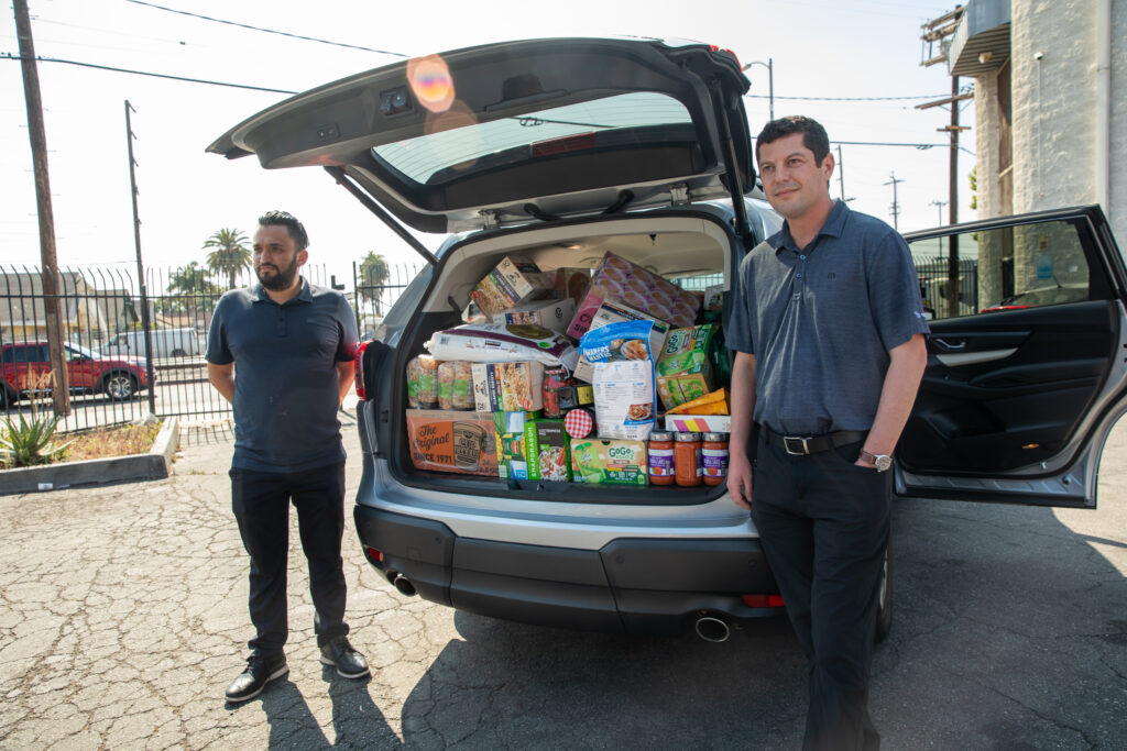 Subaru associates open a car full of food resources to donate to the LA Regional Food Bank during the 12th Annual Feed SoCal event