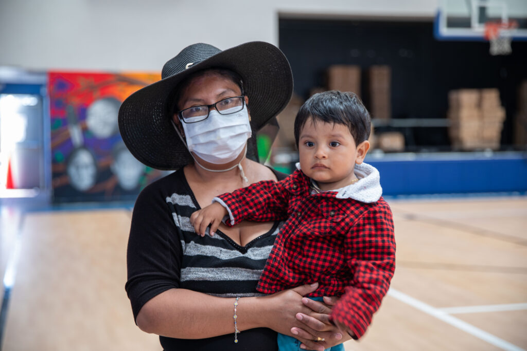 Marisol, food recipient at All Peoples Community Center, with her infant son