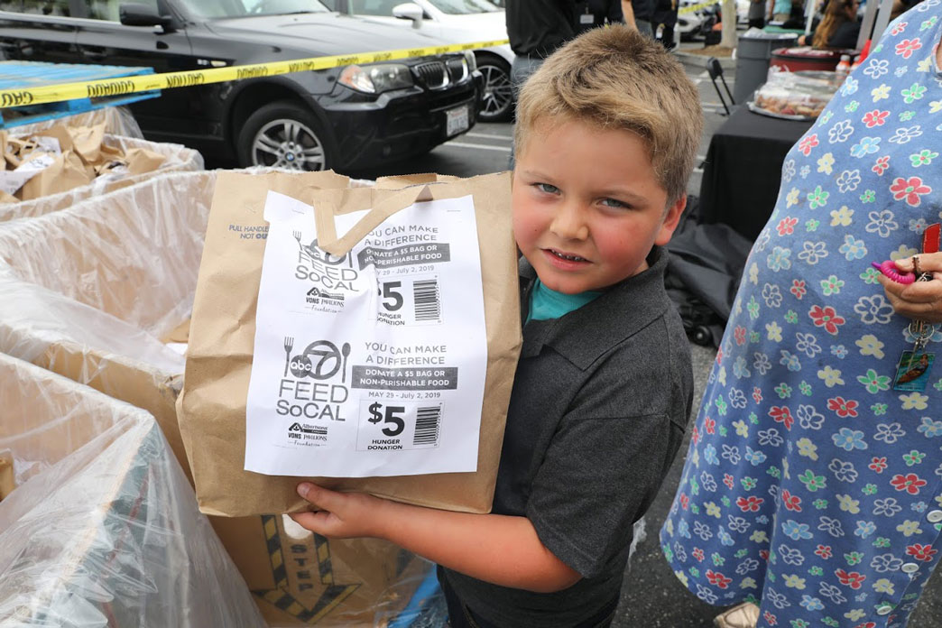 Young boy donates Feed SoCal bag