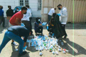 group of students collect plastic bottles