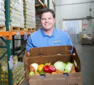 Michael Flood CEO Food Bank with produce