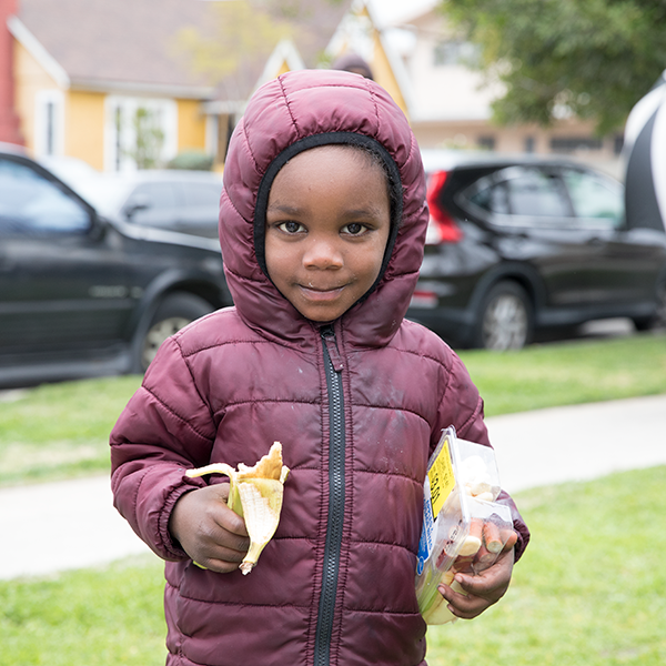 Young boy outside My Friends House distribution.