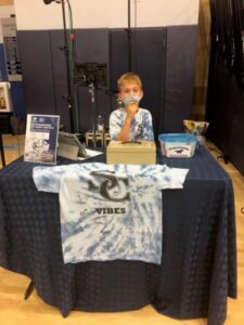 Quinn at a basketball game raffling an autographed shirt benefiting the LA Regional Food Bank.