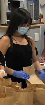 Rachel and her coworkers recently helped to assemble sack lunches for our neighbors in need currently experiencing homelessness. This event was organized by Rachel's company leadership via UPLIFT LA and Midnight Mission. A medical frontline worker assembling lunches for those facing home insecurity in Los Angeles.