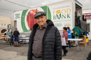 Senior smiles at food distribution site