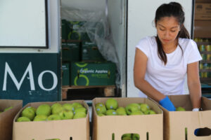Young woman volunteering at the Mobile Food Pantry.