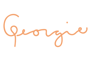 The image features the word "Georgie" written in orange cursive letters on a plain white background, reminiscent of the vibrant energy found at events supporting the Los Angeles Regional Food Bank.