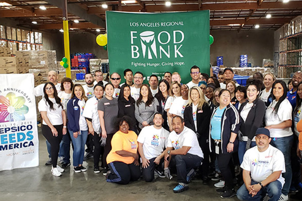 group of volunteers gathered in a warehouse