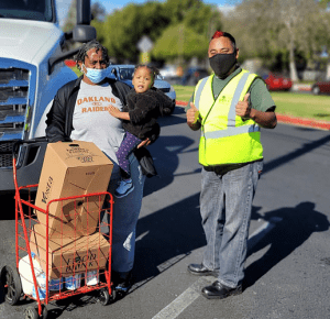 Food Bank truck driver and food recipient with child