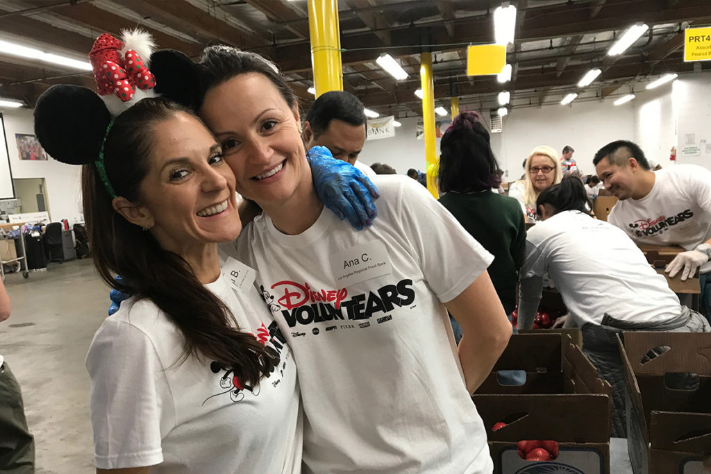 two volunteers smiling in warehouse